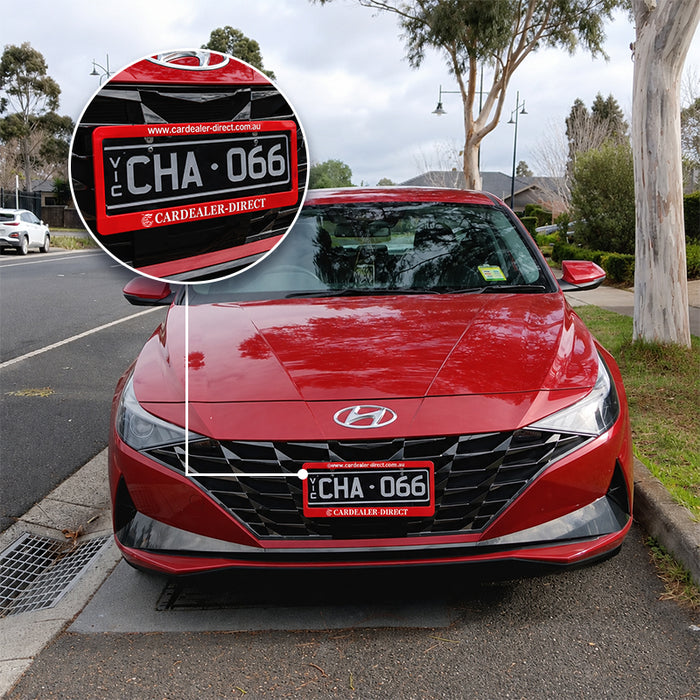 Red custom dealership number plate frame fitted to a vehicle
